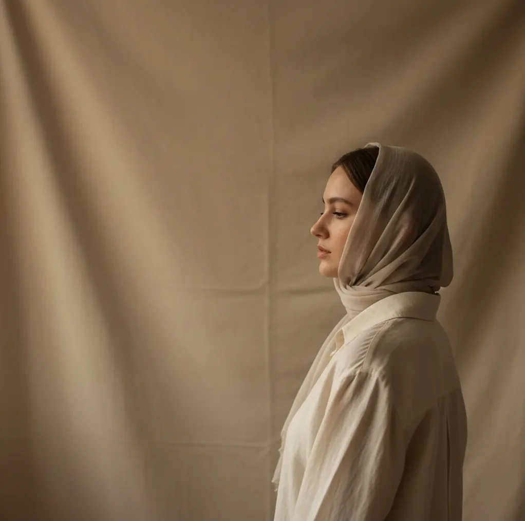 Natural-looking studio-style portrait on a neutral background with soft light and clean framing